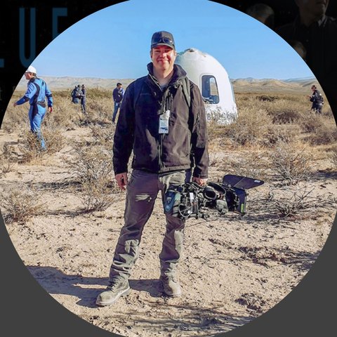 Kevin Curran with his camera beside the New Shepard capsule after the NS-19 landing in West Texas